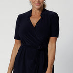 Kris dress in Navy is a functioning wrap dress in navy. Featuring a mandarin collar and short sleeves. Gathered at the waist with a functioning tie. Made in Australia for women size 8 - 24.