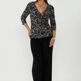 Featuring a flattering wrap bodice and soft peplum waist seam, the Kyle Top is perfect for polished workwear dressing.