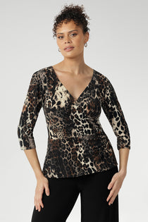 The Kyle Top in Panthera—a bold cheetah print—features a fixed wrap bodice that stays perfectly in place, offering the elegance of a wrap design without the need for constant adjustment.