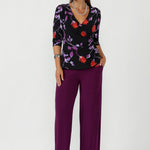 Featuring a wrap bodice, 3/4 length sleeves, and a soft peplum waist seam that adds sophistication.