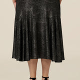 Back view of a midi length, foil print evening skirt with ruffle hem in plus size. For cocktail and evening wear, this elegant skirt is made in Australia by women's fashion brand, Leina & Fleur. Shop their evening and cocktail wear online in sizes 8 to 24.