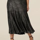 A size 10, petite height woman wears a midi length, foil print evening skirt with ruffle hem. For cocktail and evening wear, this elegant skirt is made in Australia by women's fashion brand, Leina & Fleur. Shop their evening and cocktail wear online in sizes 8 to 24.