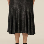 Back view of a midi length, foil print evening skirt with ruffle hem. An elegant skirt for cocktail and evening wear, this below-the-knee skirt is made in Australia by women's fashion brand, Leina & Fleur. Shop their evening and cocktail wear online in petite to plus sizes.