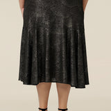 Back view of a midi length, foil print evening skirt with ruffle hem. An elegant skirt for cocktail and evening wear, this below-the-knee skirt is made in Australia by women's fashion brand, Leina & Fleur. Shop their evening and cocktail wear online in petite to plus sizes.