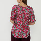 Refined Lila Top crafted from signature stretch jersey fabric with elegant flutter sleeves, a centre-back tuck for movement and a polished Australian-made finish.