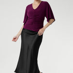 The Luna Top is expertly crafted from our signature dry-touch stretch jersey, offering a perfect balance of professional style and all-day comfort. This elegant top features a flattering V-neckline that adds a touch of sophistication, while the unique handkerchief sleeves bring a modern, feminine edge to your wardrobe. Designed with subtle bust darts for enhanced fit and a clean straight hemline for a polished silhouette.
