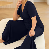 Crafted from luxe slinky fabric in a rich deep navy, the Lyle Top in Dark Navy features a flattering V-neck wrap front with a soft flounce detail. With short sleeves and a versatile silhouette, it layers effortlessly under jackets or stands alone as a polished summer essential.
