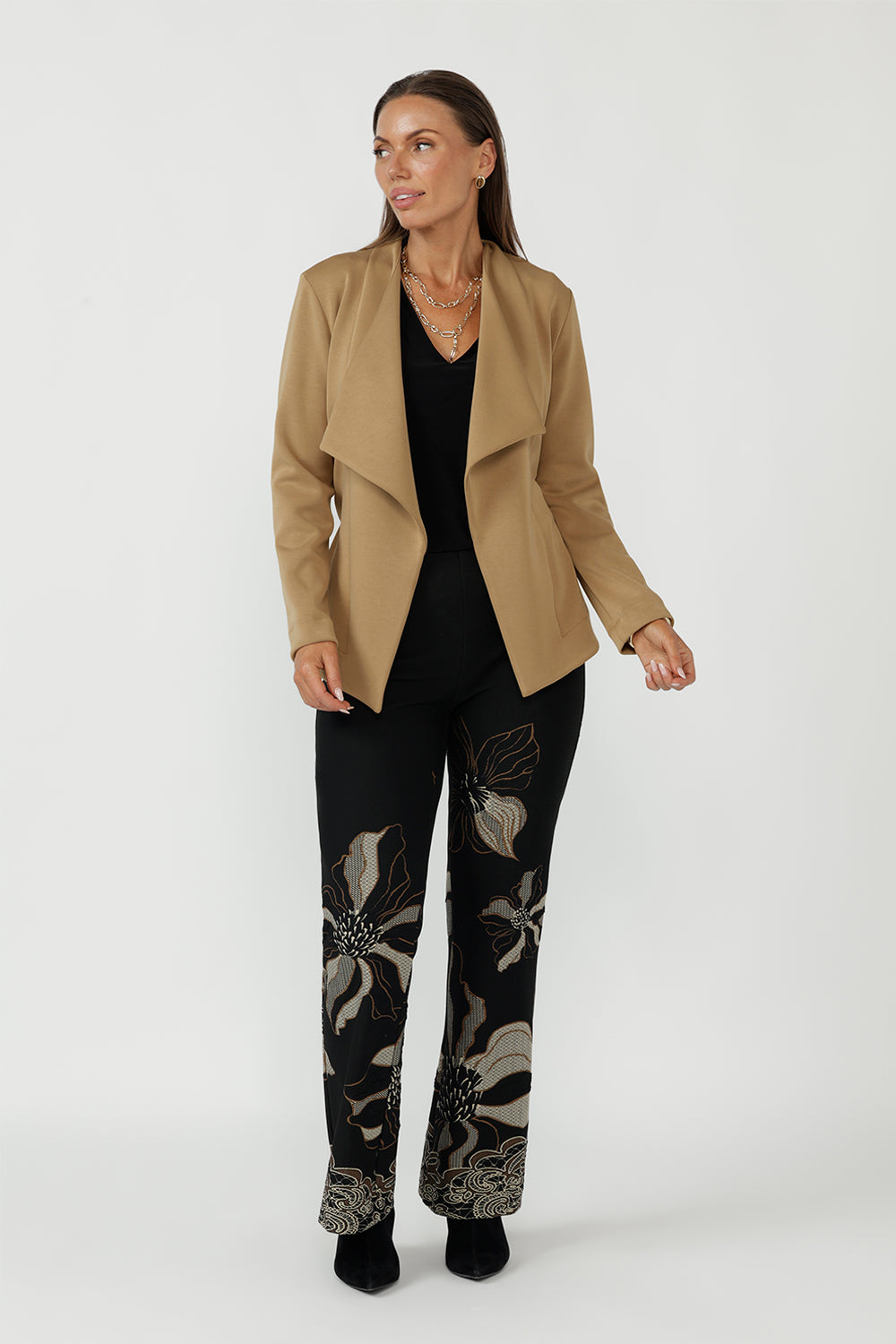 Gilded Noir Pant crafted from luxe winter-weight jacquard knit with soft stretch, featuring a textured black base with elegant toffee and cream print detailing and a flattering bootcut silhouette.