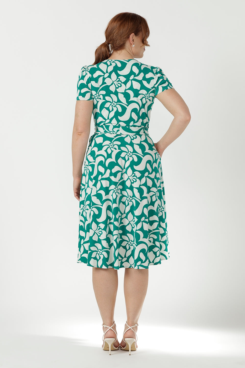 Versatile Australian-made wrap dress crafted from soft stretch jersey, featuring a defined waist, feminine sleeve detailing and functional side pockets.