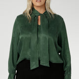 Crafted from suede touch Tencel that has a luxurious feel and drape. Proudly made in Australia in sizes 8-24. The Matisse Shirt in Deep Green is a pull-on style with a tie neckline, crafted from soft, fluid fabric. Blouson sleeves and buttoned cuffs add a polished finish. Matisse is a semi-fitted pull on style V-neckline shirt with extended neck ties, back pleats and bishop sleeves.