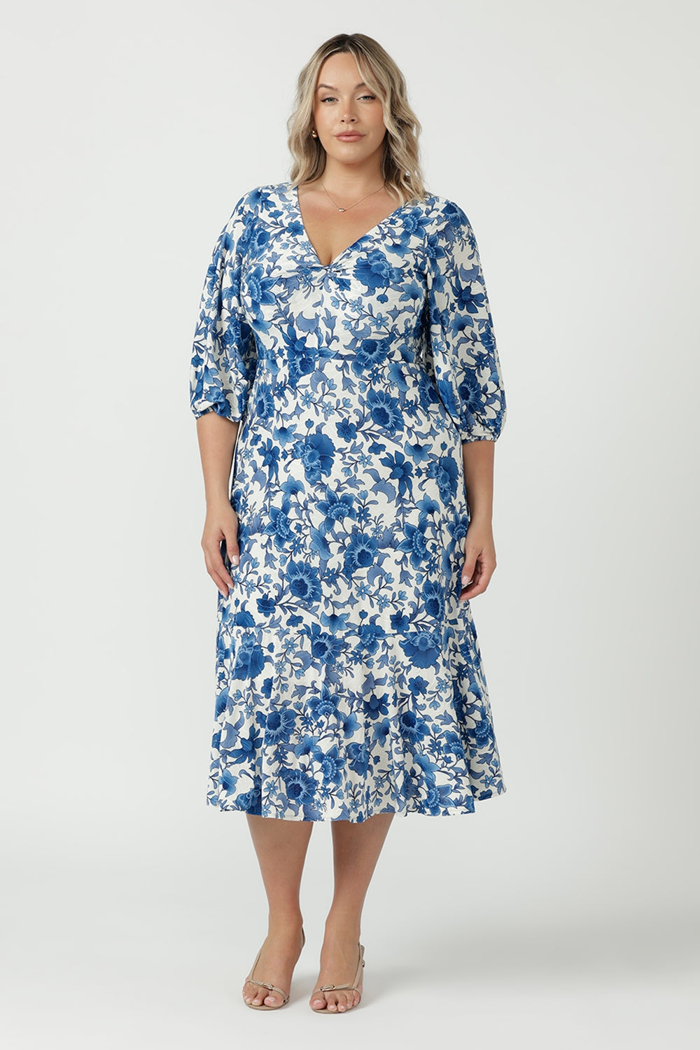 Melina Dress featuring a soft stretch embroidered jersey fabric, elegant high-low lantern sleeves and a flowing skirt with a feminine ruffled hemline.