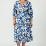 Melina Dress featuring a soft stretch embroidered jersey fabric, elegant high-low lantern sleeves and a flowing skirt with a feminine ruffled hemline.