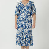 Elegant women's occasion dress crafted from cool-touch embroidered jersey, featuring a feminine twist-front bodice, flowing silhouette and statement sleeves.