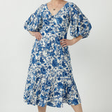 Elegant Melina Dress crafted from luxe embroidered jersey, featuring a flattering empire-line silhouette, twist-front bodice and flowing ruffle hem.