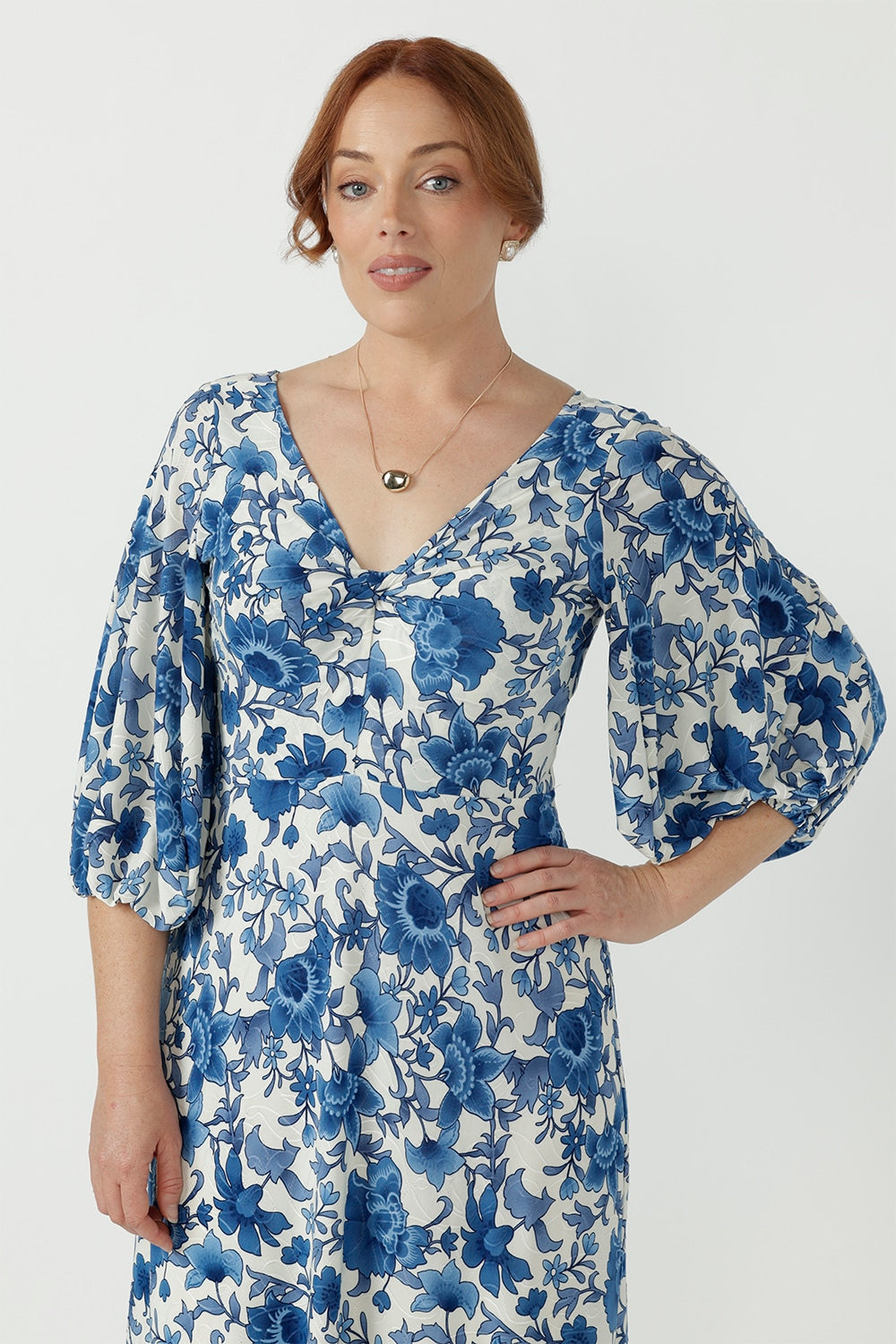 Flattering empire-line Melina Dress with a twist-front neckline, voluminous lantern sleeves, elasticated cuffs and an elegant ruffle hem.