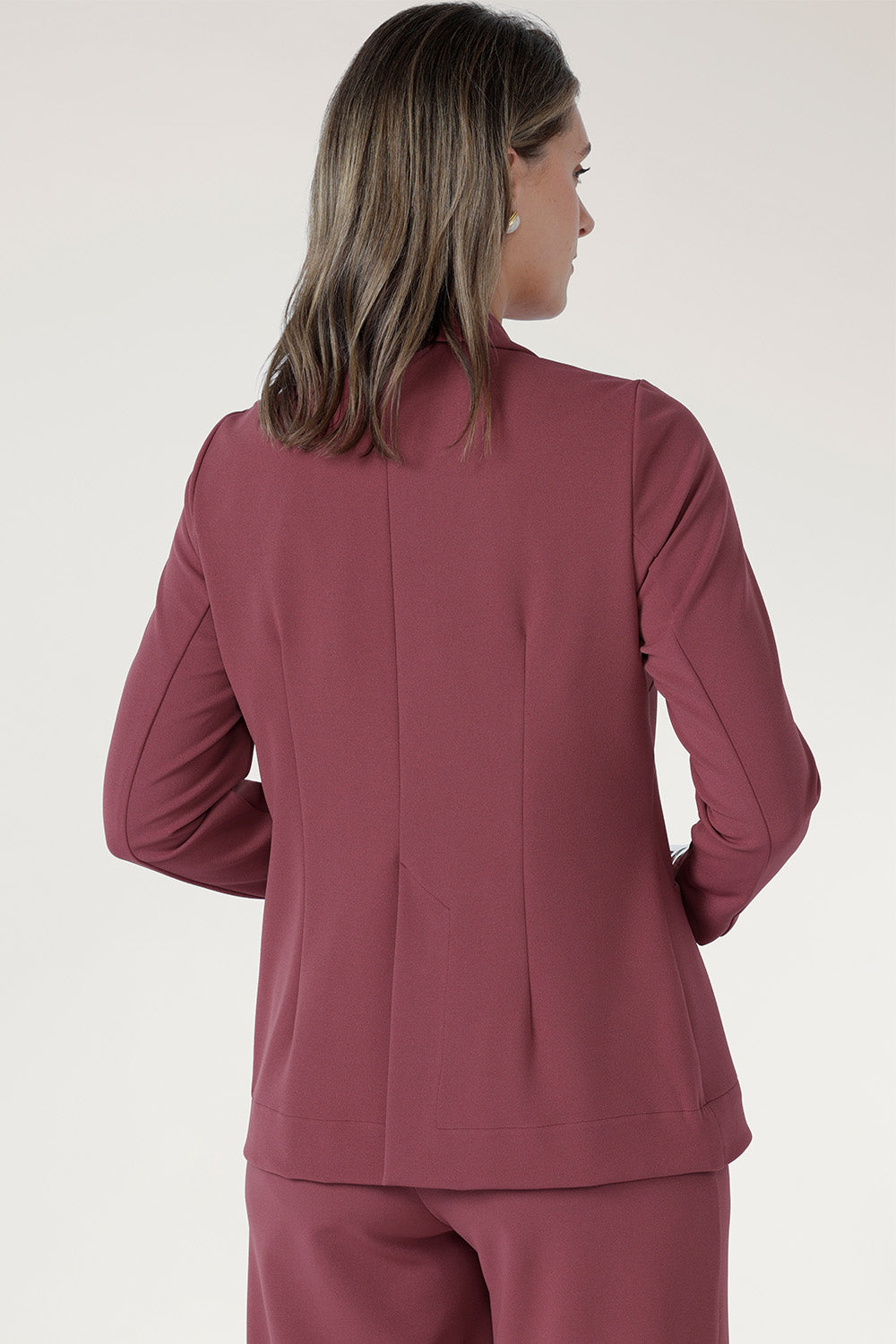 Designed in a longline, relaxed fit, it features an extended shawl collar that creates a refined, elongating silhouette. 
