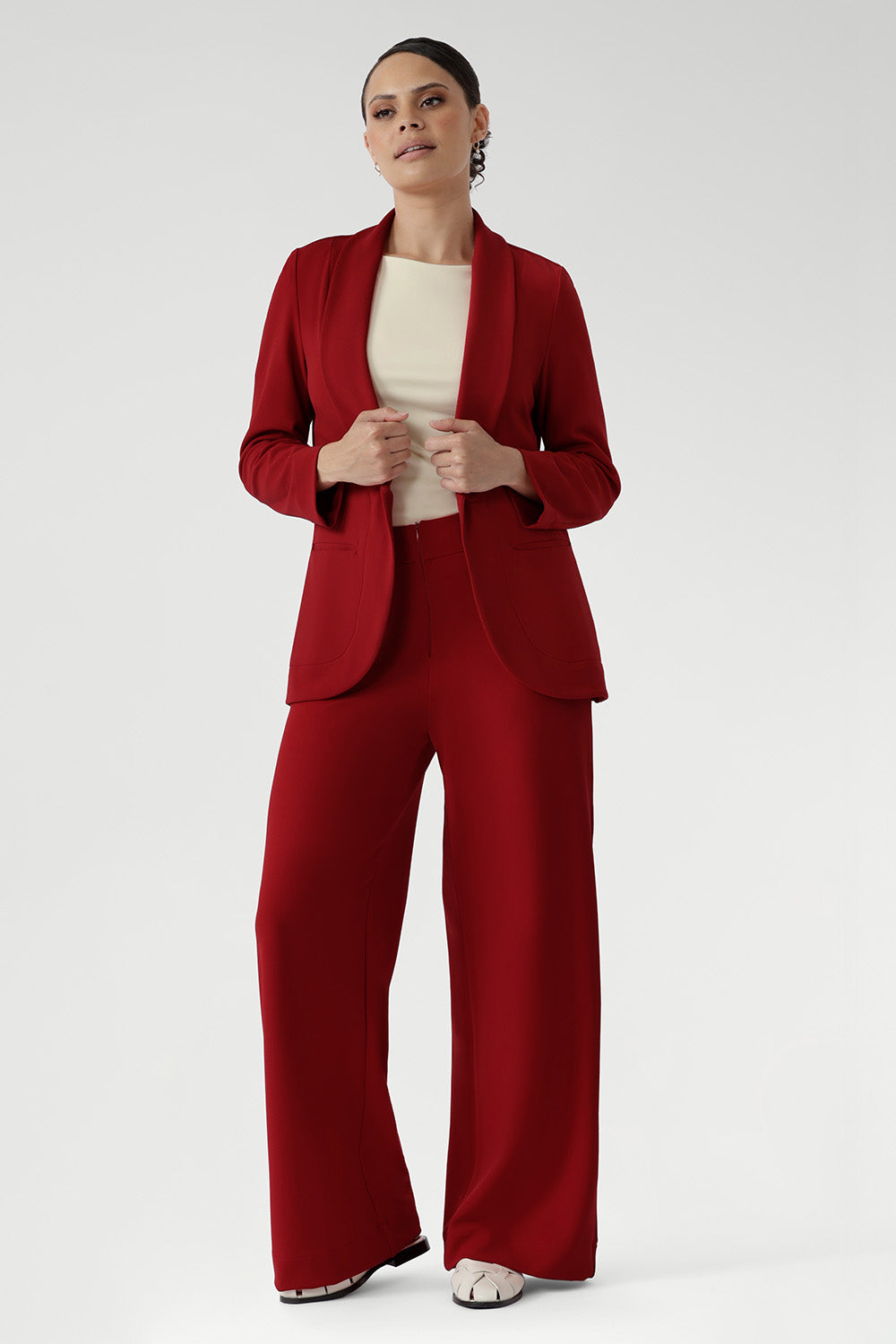 Bright red coloured blazer, a textured scuba crepe. Red work blazer is worn with black skirt and white t-shirt. Curved hemline and front pockets. This blazer is Made in Australia for petite women in sizes 8 - 24.