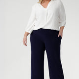 The clean straight-leg cut and deep hem create a modern, elongated line that works seamlessly from work to weekend.
