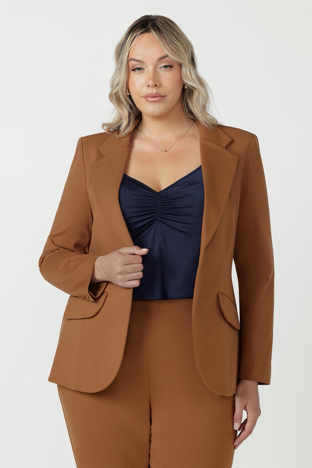 Close-up of the toffee Longline Tailored Jacket sleeve vent with three buttons and a clean blind hem.