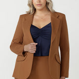 Close-up of the toffee Longline Tailored Jacket sleeve vent with three buttons and a clean blind hem.