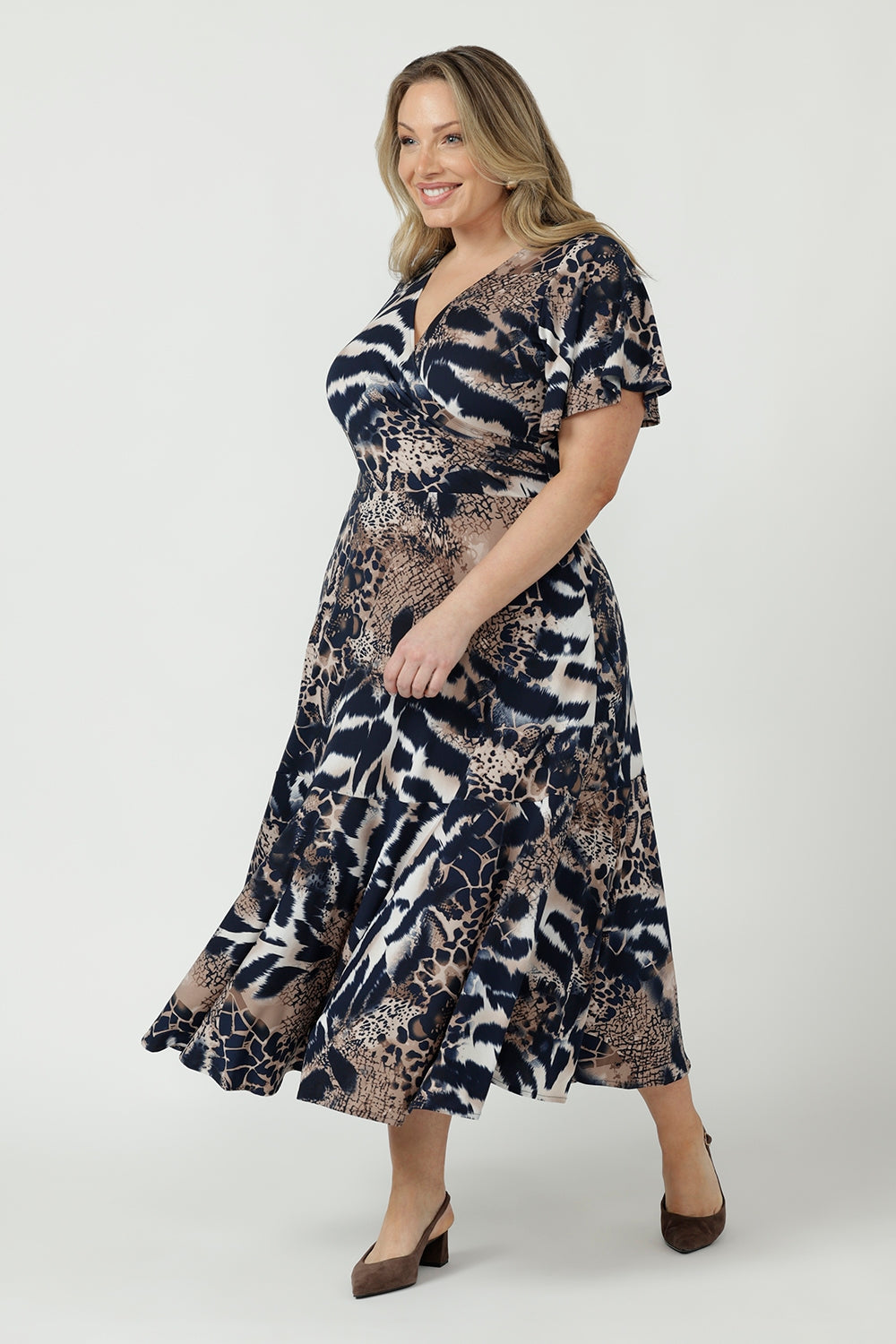 Women’s Nicolle Dress in soft stretch jersey with a feminine wrap-front silhouette, flutter sleeves, full flowing skirt and practical side pockets.