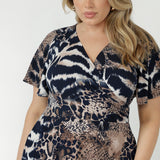 Nicolle fixed-wrap dress crafted from premium dry-touch stretch jersey with a double-layer back bodice, lined skirt and feminine ruffle hem detailing.
