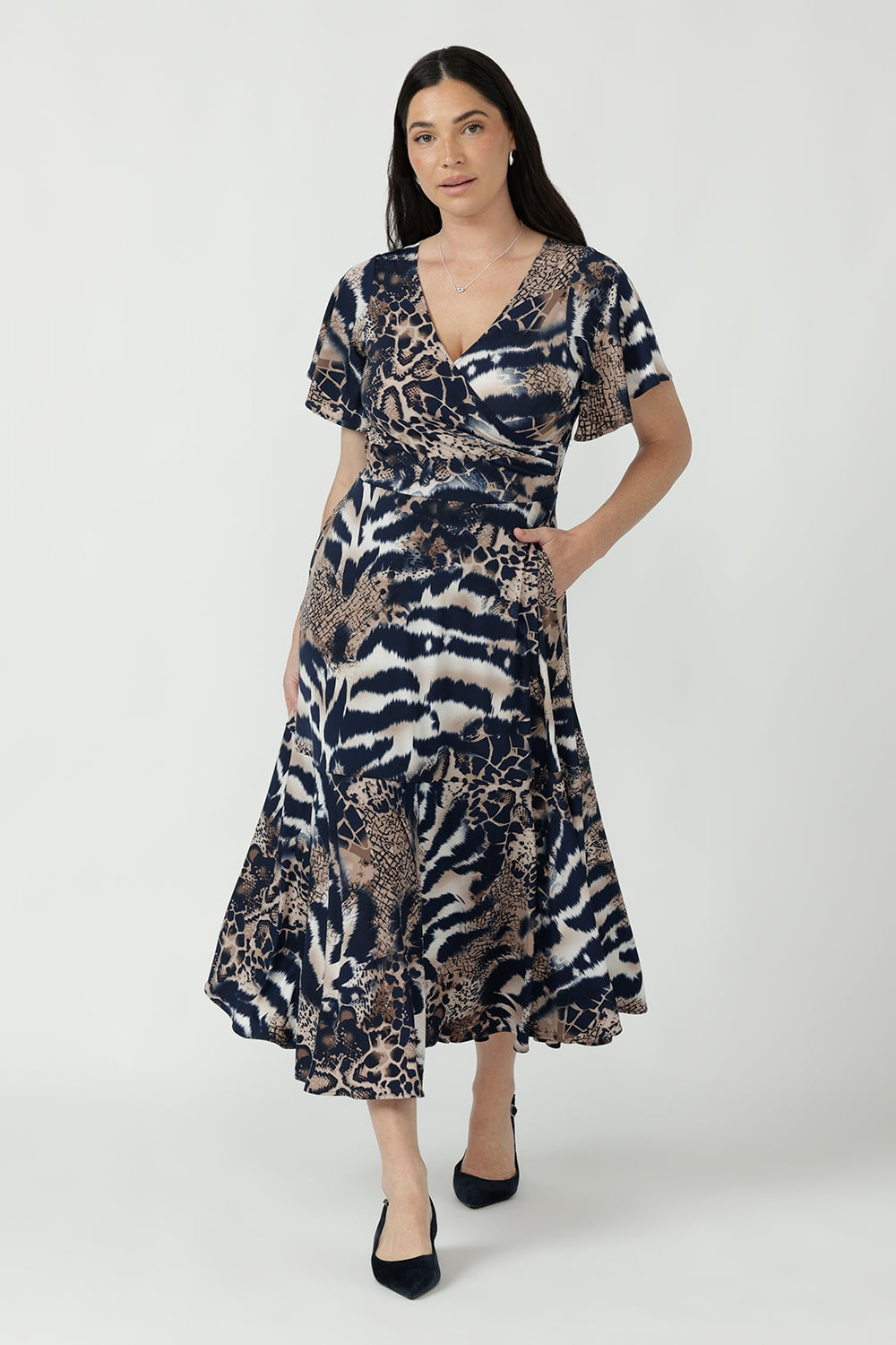 Nicolle Dress crafted from signature dry-touch stretch jersey, featuring a flattering fixed-wrap front, soft flutter sleeves and a flowing ruffle hem skirt.