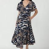 Nicolle Dress crafted from signature dry-touch stretch jersey, featuring a flattering fixed-wrap front, soft flutter sleeves and a flowing ruffle hem skirt.