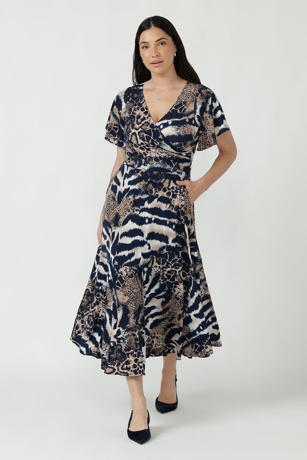 Nicolle Dress crafted from signature dry-touch stretch jersey, featuring a flattering fixed-wrap front, soft flutter sleeves and a flowing ruffle hem skirt.
