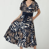Elegant Nicolle Dress with a flattering wrap-front design, soft flutter sleeves and flowing full skirt, available in inclusive women’s sizes 8–24.