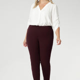 Plus size woman wears Burgundy Paxton Pant. Designed as a pull-on style pant, crafted from dry touch Ponte fabric that provides firm stretch and full body comfort. Size 18 model wears the Garcia Jacket in the matching burgundy colour for a coordinated suiting look.