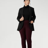 Petite Height woman wears Size 10 pull-on style pant, crafted from stretchy, dry touch Ponte fabric that provides firm stretch and full body comfort. Available in sizes 8-24. Workwear pants are available in 3 lengths.