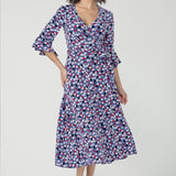 Featuring a soft wrap neckline, fluted 3/4 sleeves with gathered detail, and pockets, it’s designed with comfort, elegance and movement in mind.