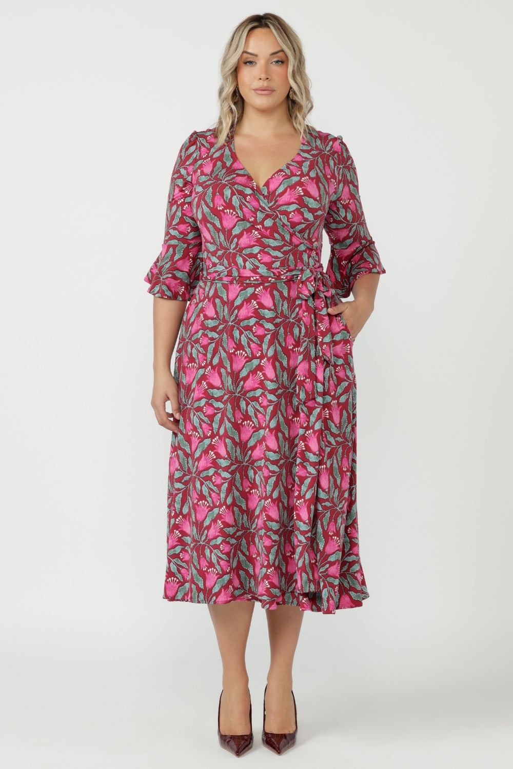 Women's Portia Wrap Dress in soft stretch jersey with a feminine wrap silhouette, gathered 3/4 sleeves and side pockets for comfort and sophistication.