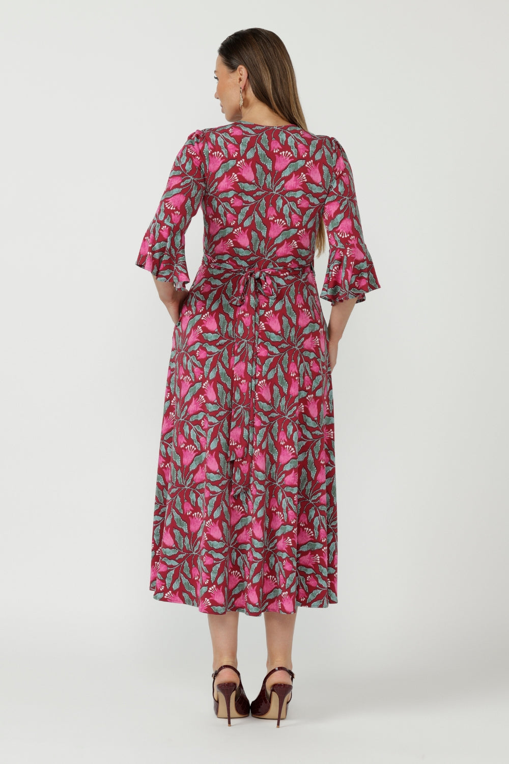 Elegant Portia Wrap Dress crafted from luxe stretch jersey, featuring a soft wrap neckline, gathered sleeve detailing and practical side pockets.