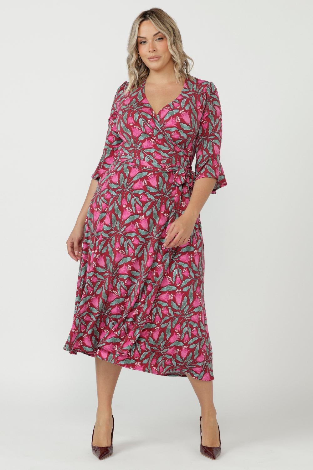 Sophisticated Portia Wrap Dress featuring a flattering wrap bodice, soft stretch fabrication and feminine fluted sleeves designed for comfort and elegance.