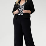 The Puzzle Jumpsuit in Moderno is a statement-making one-piece crafted from our signature dry-touch jersey with soft stretch, designed to offer effortless style and all-day comfort. Showcasing a striking black and white geometric print across the wrap-style bodice, this jumpsuit features a flattering self-tie waist and a double-layered back for a refined and supportive fit.