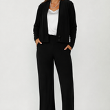 Soft suiting Sandro cardigan with deep V-neck, long sleeves and structured covered button closure for polished everyday layering.