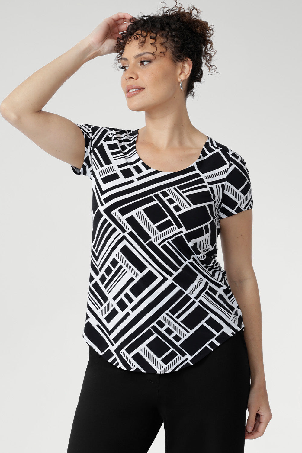 The Sawyer Top in Moderno is crafted from our signature dry-touch stretch jersey, offering the perfect balance of structure and softness for everyday wear. Designed with a flattering fitted silhouette, this versatile top features a classic round neckline, short sleeves, and a curved shirttail hemline that adds a modern touch to any outfit.