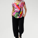 The Tucan print blends abstract strokes of pinks, reds, greens, and black on a warm cream base, creating a vibrant, artful pop that enlivens any outfit. Wear with tailored pants and or summer skirts.
