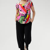 The Tucan print blends abstract strokes of pinks, reds, greens, and black on a warm cream base, creating a vibrant, artful pop that enlivens any outfit. Wear with tailored pants and or summer skirts.
