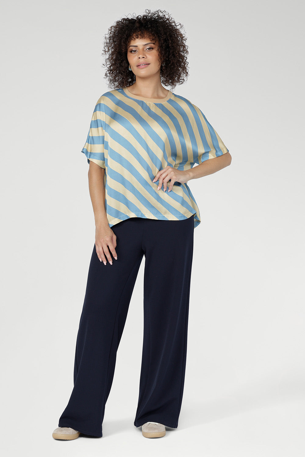The Blue Sky Stripe print blends soft sky blue and vanilla tones, giving this tee a fresh, modern aesthetic. The diagonal stripe design adds subtle movement and visual interest to an everyday essential.