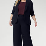 Designed for versatility and ease, the Scout Tee is your go-to essential for timeless, elevated dressing this season. Size 18 model wears Scout Tee in Plum with Drew Pant in Navy & Merit Blazer in Navy, creating a relaxed suiting look. 