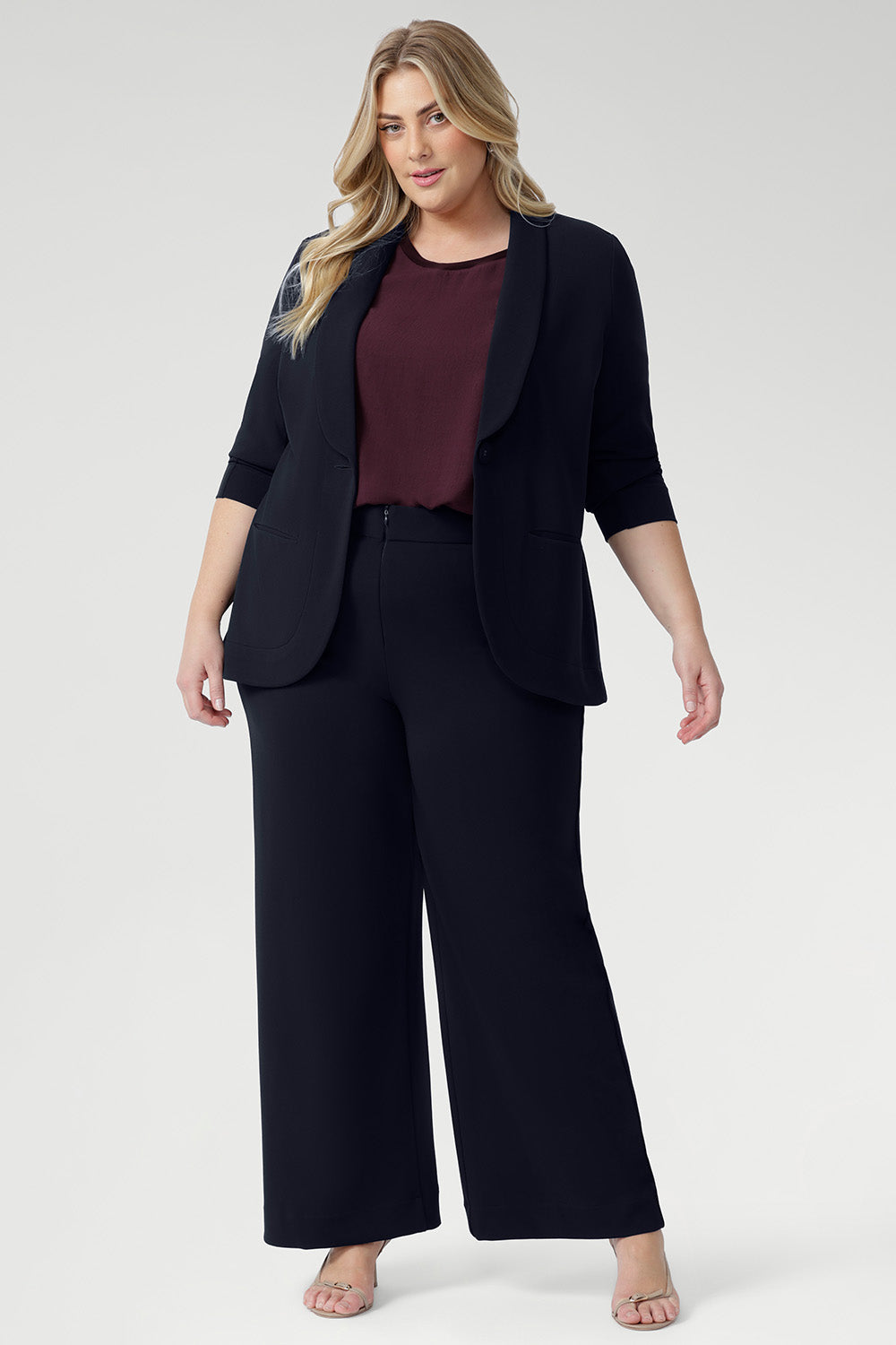 Designed for versatility and ease, the Scout Tee is your go-to essential for timeless, elevated dressing this season. Size 18 model wears Scout Tee in Plum with Drew Pant in Navy & Merit Blazer in Navy, creating a relaxed suiting look. 