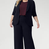 Designed for versatility and ease, the Scout Tee is your go-to essential for timeless, elevated dressing this season. Size 18 model wears Scout Tee in Plum with Drew Pant in Navy & Merit Blazer in Navy, creating a relaxed suiting look. 