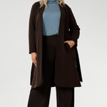 Made from a blend of stretchy Tencel wool fabric, it offers both flexibility and coziness, making it the perfect layering piece for cooler weather. Size 18 model wears her turtle neck top under her soft suiting, pairing her Pennyworth vest over the tencel wool top.