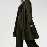 Crafted from a luxurious winter-weight Modal fabric, it combines soft structure and stretch, making it the perfect travel companion for those seeking both style and comfort. The coat features tailored panels at the front with concealed pockets seamlessly integrated into the seams, along with two-piece long sleeves for a refined fit. 