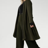 Crafted from a luxurious winter-weight Modal fabric, it combines soft structure and stretch, making it the perfect travel companion for those seeking both style and comfort. The coat features tailored panels at the front with concealed pockets seamlessly integrated into the seams, along with two-piece long sleeves for a refined fit. 