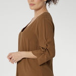 Versatile shirttail hemline allows you to style it tucked in or worn loose, making it perfect for layering from desk to dinner. 