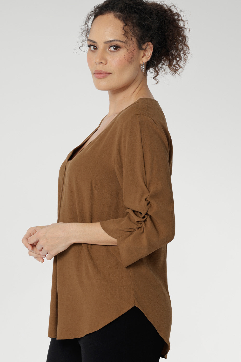 Versatile shirttail hemline allows you to style it tucked in or worn loose, making it perfect for layering from desk to dinner. 